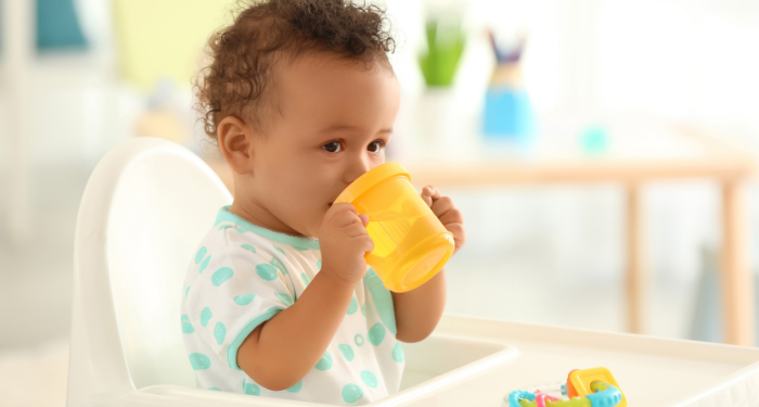 child drinking from a sippy cup